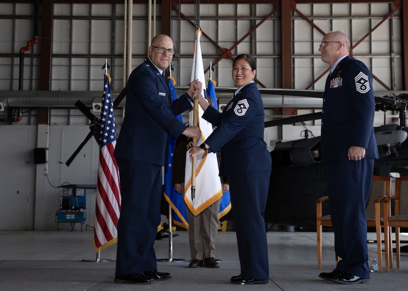 Chief Master Sgt. Kim T. Groat relinquishes the position of the State Command Chief Master Sergeant of the Alaska Air National Guard to Chief Master Sgt. Jeffrey A. Ling during a change of responsibility ceremony at Joint Base Elmendorf-Richardson, Alaska, June 18, 2025. Brig. Gen. Brian D. Kile, the commander of the Alaska Air National Guard, presided over the ceremony.
