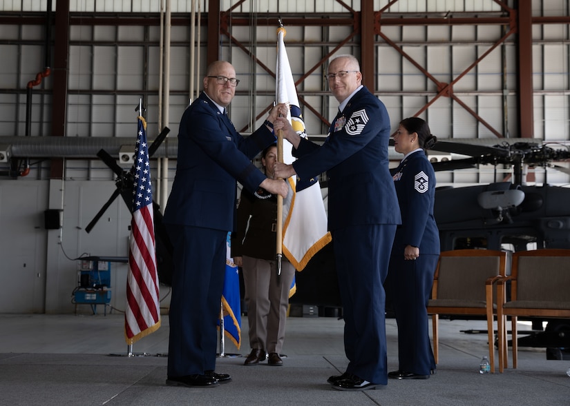 Chief Master Sgt. Kim T. Groat relinquishes the position of the State Command Chief Master Sergeant of the Alaska Air National Guard to Chief Master Sgt. Jeffrey A. Ling during a change of responsibility ceremony at Joint Base Elmendorf-Richardson, Alaska, June 18, 2025. Brig. Gen. Brian D. Kile, the commander of the Alaska Air National Guard, presided over the ceremony.