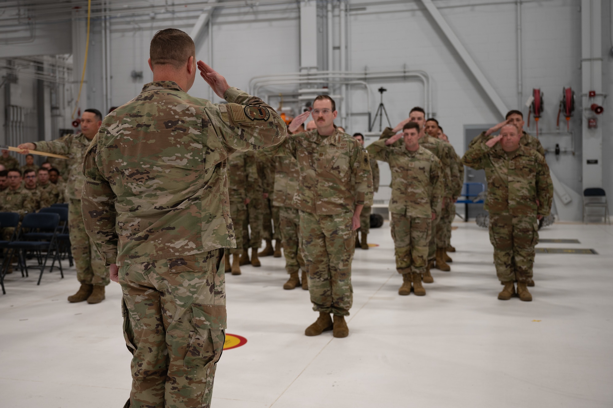 U.S. Air Force Maj. Garrett Evans, 354th Munitions Squadron incoming commander, renders an initial salute to the formation during a change of command ceremony at Eielson Air Force Base, Alaska, June 26, 2025.