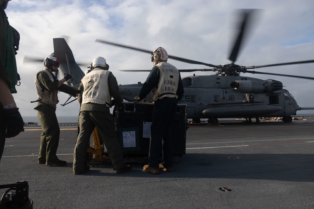 U.S. Marines with 31st Marine Expeditionary Unit, prepare to load forward arming and refueling point equipment aboard a CH-53E Super Stallion assigned to Marine Tiltrotor Squadron 265 (Rein.) during forward arming and refueling point flight support operations aboard the amphibious assault ship USS America (LHA 6), in the Coral Sea, June 23, 2025. Marines with VMM 265 (Rein.) enable FARP support flight operations by loading and transporting mission essential equipment. The FARP is a multi-discipline operation that increases the speed of maneuver for aerial operations, utilizing expeditionary advanced base operations, enhancing strike capabilities by decreasing the distance required for refueling and rearming while increasing the range of combined-joint all domain operation capabilities. The 31st MEU is operating aboard ships of the USS America Amphibious Ready Group in the 7th Fleet area of operations, the U.S. Navy’s largest forward-deployed numbered fleet, and routinely interacts and operates with allies and partners in preserving a free and open Indo-Pacific region. (U.S. Marine Corps photo by Sgt. Peter Rawlins)