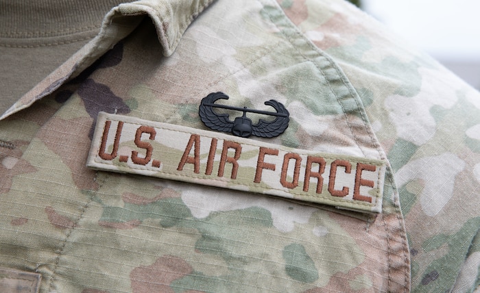 The Air Assault badge pinned on an Airman's chest above the U.S. Air Force nametape.