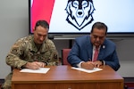 U.S. Air Force Col. Tyler Ellison, 47th Flying Training Wing commander, and Sul Ross State University President Carlos Hernandez sign a memorandum of understanding during a partnership event at Sul Ross State University in Del Rio, Texas, June 25, 2025. The agreement expands opportunities for Airmen to pursue higher education and professional development. (U.S. Air Force photo by Joseph Pagan)