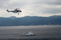 A Japan Coast Guard helicopter lowers a rescue diver during a trilateral search and rescue exercise with the U.S. Coast Guard Cutter Stratton (WMSL 752) and the Philippine Coast Guard vessel BRP Teresa Magbanua (MRRV-9701) in Kagoshima, Japan, June 2025. Stratton is deployed and assigned to Destroyer Squadron (DESRON) 15, the Navy’s largest DESRON and the U.S. 7th Fleet’s principal surface force. Stratton is deployed to the Indo-Pacific to advance relationships with ally and partner nations to build a more secure and prosperous region with unrestricted, lawful access to the maritime commons. (U.S. Coast Guard photo by Senior Chief Petty Officer Matthew S. Masaschi)