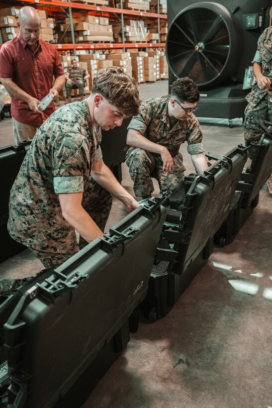 U.S. Marines and civilian personnel receive and inspect the Handheld Radio Test Set (HHRTS) during fielding with II Marine Expeditionary Force at Marine Corps Base Camp Lejeune, N.C., on May 21, 2025.