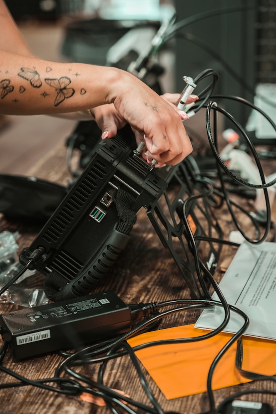 U.S. Marines and civilian personnel receive and inspect the Handheld Radio Test Set (HHRTS) during fielding with II Marine Expeditionary Force at Marine Corps Base Camp Lejeune, N.C., on May 21, 2025.