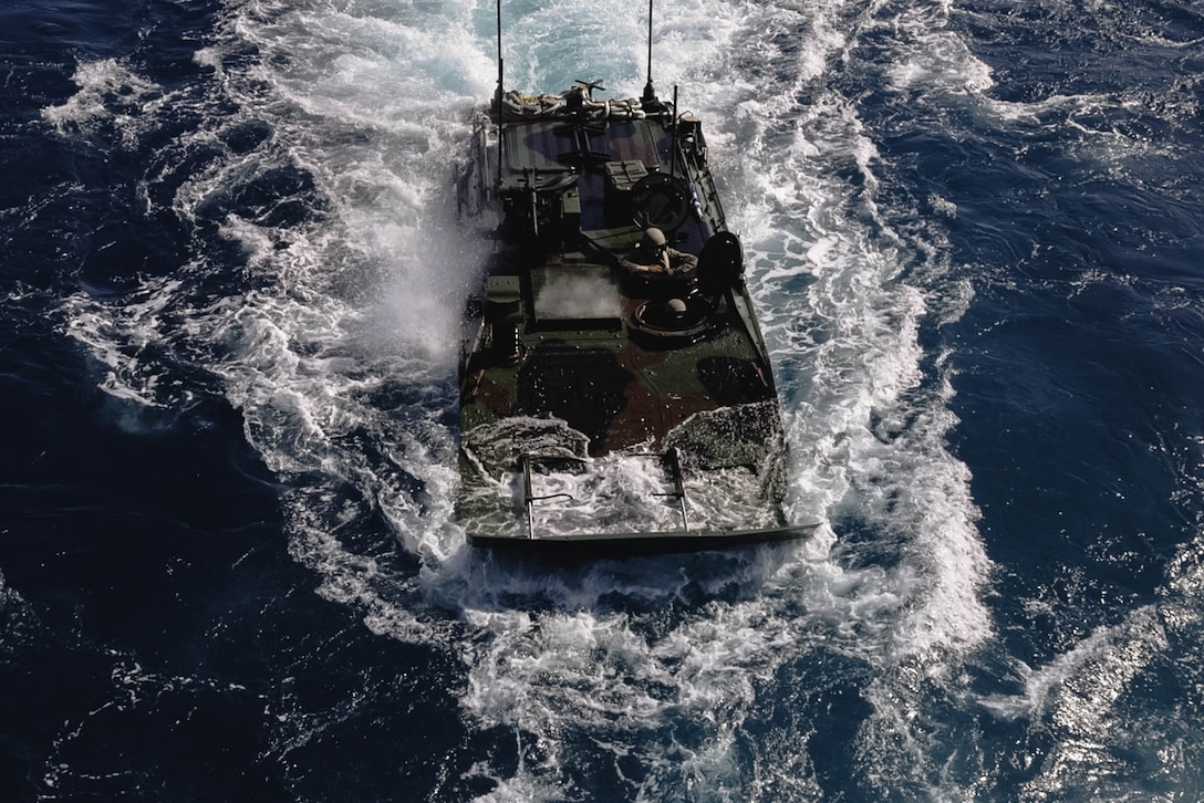 U.S. Marines with Charlie Company, Battalion Landing Team 1st Battalion, 7th Marine Regiment, 31st Marine Expeditionary Unit, recover an Amphibious Combat Vechicle onto amphibious dock landing ship USS Rushmore (LSD 47) during amphibious operations in the Coral Sea, June 24, 2025. The ACV provides the MEU a ship-to-objective amphibious capability, land mobility, survivability and growth capacity and flexibility to incorporate and adapt future technologies. The 31st MEU is operating aboard ships of the USS America Amphibious Ready Group in the 7th Fleet area of operations, the U.S. Navy’s largest forward-deployed numbered fleet, and routinely interacts and operates with allies and partners in preserving a free and open Indo-Pacific region. (U.S. Marine Corps photo by Cpl. Angel Diaz Montes De Oca)