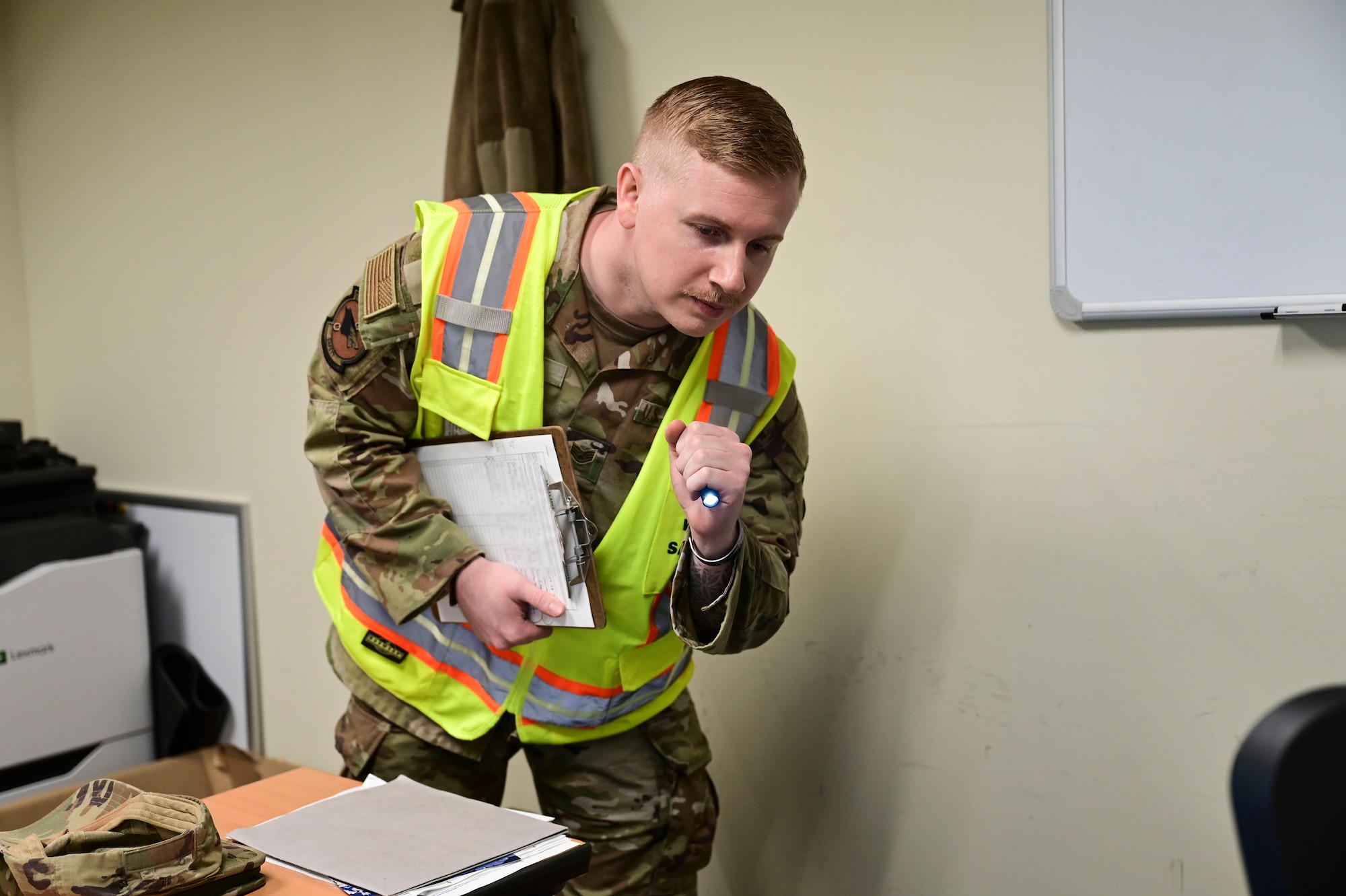 U.S. Air Force Staff Sgt. Tyler Plourde, 8th Fighter Wing noncommissioned officer in charge of occupational safety, inspects an office space for safety hazards at Kunsan Air Base, Republic of Korea, June 27, 2025.