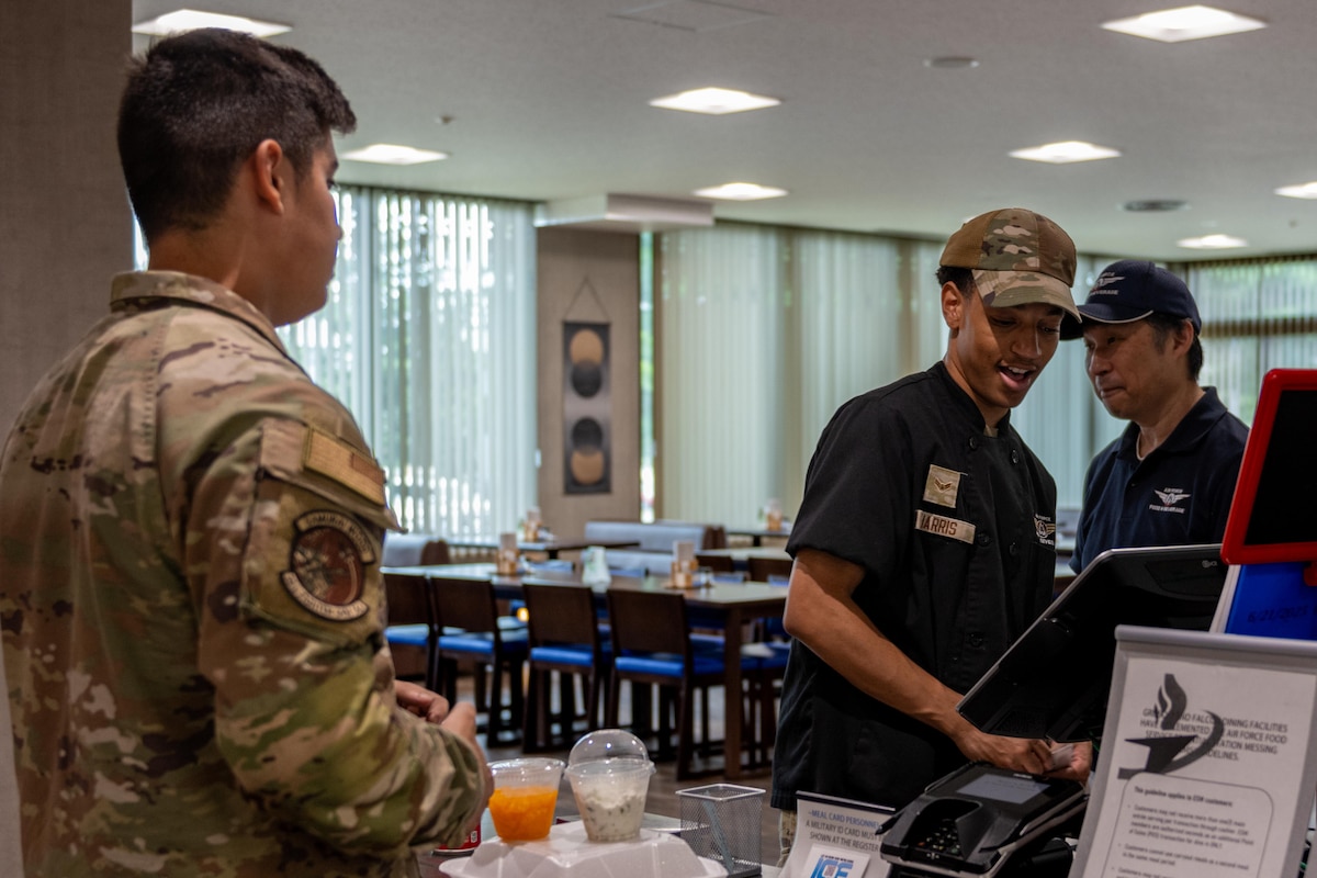 U.S. Air Force Airman 1st Class Cameron Harris, 35th Force Support Squadron food service technician, assists a customer.