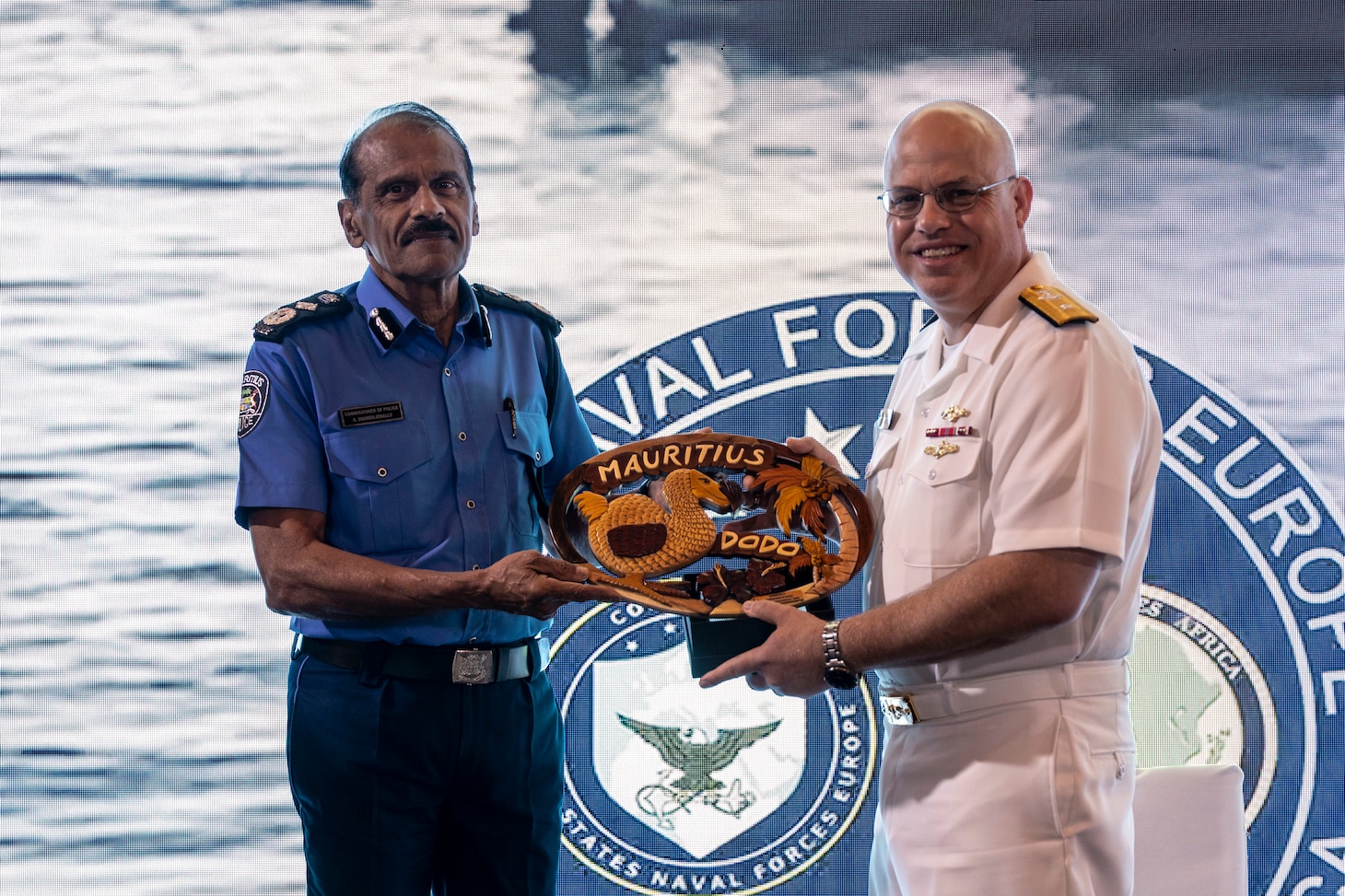 Mr. Rampersad Sooroojebally, Mauritian Commissioner of Police, left, presents a gift to U.S. Navy Rear Adm. Michael S. Mattis, commander, Command Task Force 66, right, at a closing ceremony in Pointe aux Piments, Mauritius, June 25, 2025. African Maritime Forces Summit is a summit that seeks to bring together senior leaders from African maritime forces, naval infantries, and militaries, alongside international partners, to address critical maritime security challenges facing the African continent.