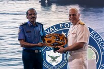 Mr. Rampersad Sooroojebally, Mauritian Commissioner of Police, left, presents a gift to U.S. Navy Rear Adm. Michael S. Mattis, commander, Command Task Force 66, right, at a closing ceremony in Pointe aux Piments, Mauritius, June 25, 2025. African Maritime Forces Summit is a summit that seeks to bring together senior leaders from African maritime forces, naval infantries, and militaries, alongside international partners, to address critical maritime security challenges facing the African continent.