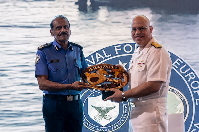 Mr. Rampersad Sooroojebally, Mauritian Commissioner of Police, left, presents a gift to U.S. Navy Rear Adm. Michael S. Mattis, commander, Command Task Force 66, right, at a closing ceremony in Pointe aux Piments, Mauritius, June 25, 2025. African Maritime Forces Summit is a summit that seeks to bring together senior leaders from African maritime forces, naval infantries, and militaries, alongside international partners, to address critical maritime security challenges facing the African continent.