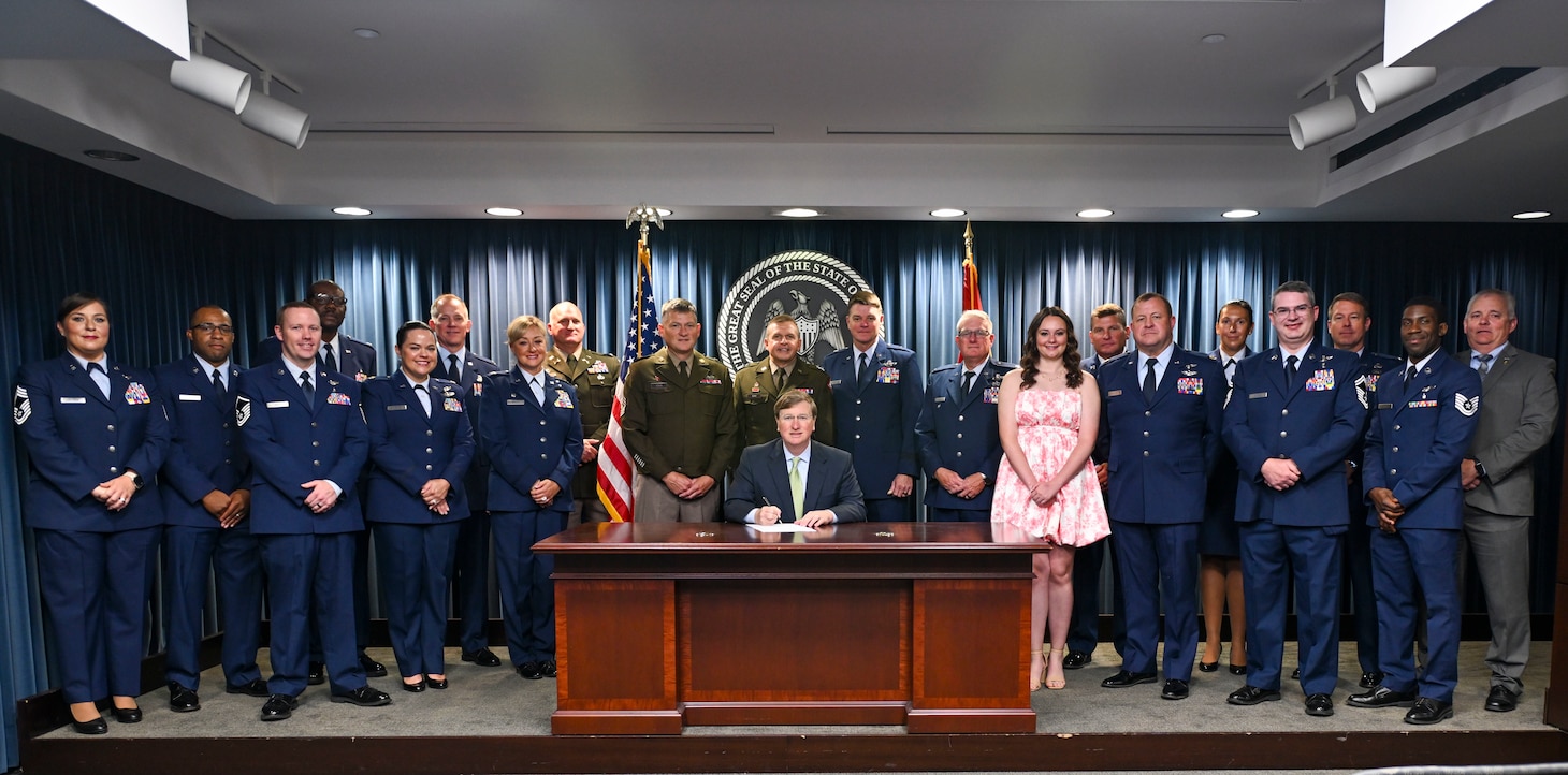 Gov. Tate Reeves signs House Bill 1262 into law alongside service members from the Mississippi Army and Air National Guard, June 25, 2025, in Jackson, Mississippi. The bill authorizes licensed practical nursing applicants who are U.S. Army combat medics, U.S. Navy hospital corpsmen, or U.S. Air Force aerospace medical service specialists to obtain licensure to practice practical nursing in the state. (U.S. Air National Guard photo by Capt. Kiara Spann)