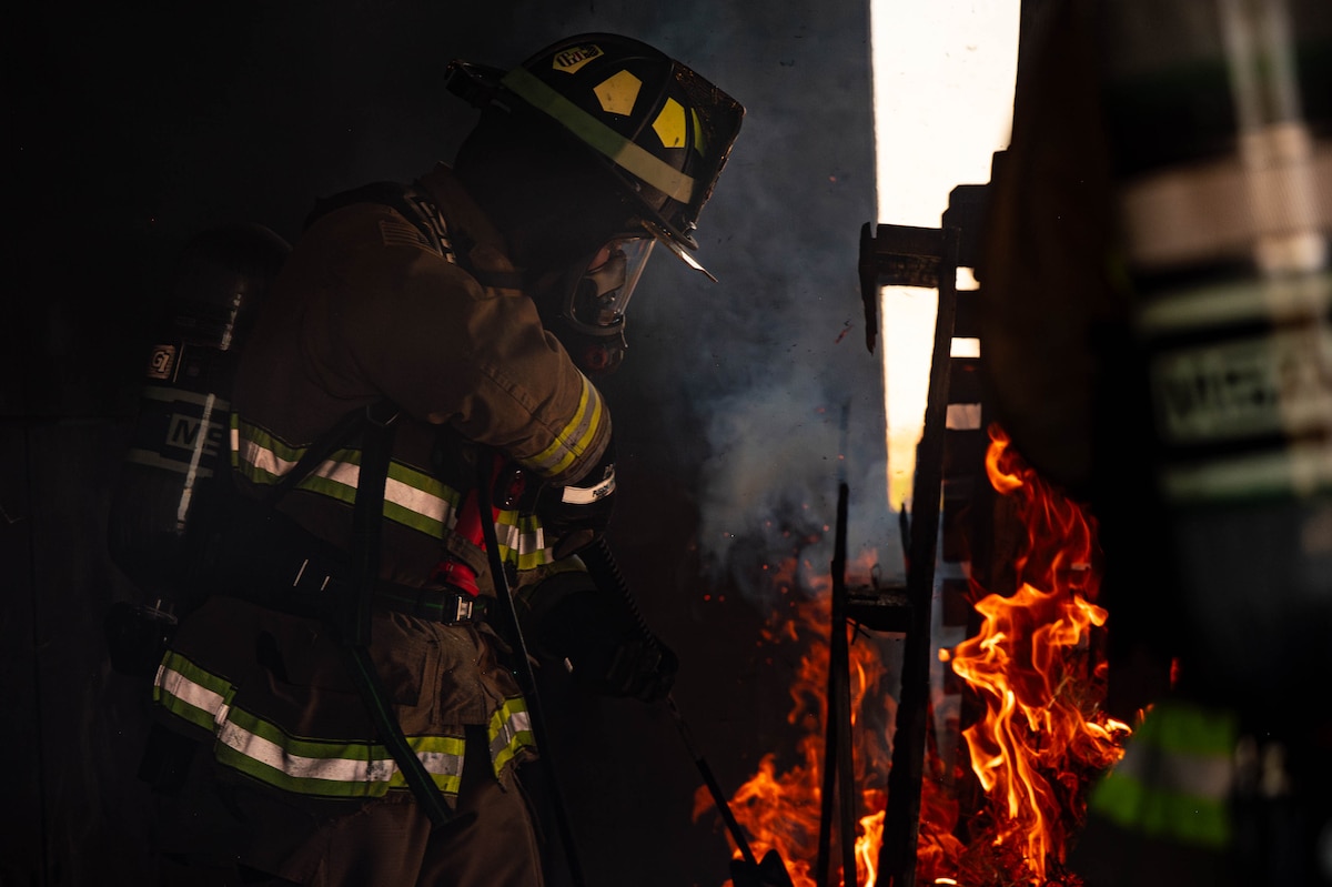 Airman 1st Class Cole Zenthofer, 341st Civil Engineer Squadron fire department vehicle driver operator, ignites a pile of kindling May 28, 2025, at Malmstrom Air Force Base, Mont. Malmstrom AFB’s multi-story structure trainer allows fire crews to simulate interior fire attacks, victim rescues and ventilation techniques in a controlled environment. (U.S. Air Force photo by Senior Airman Mary Bowers)