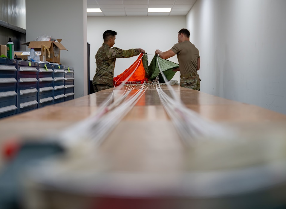 Airmen handling parachute