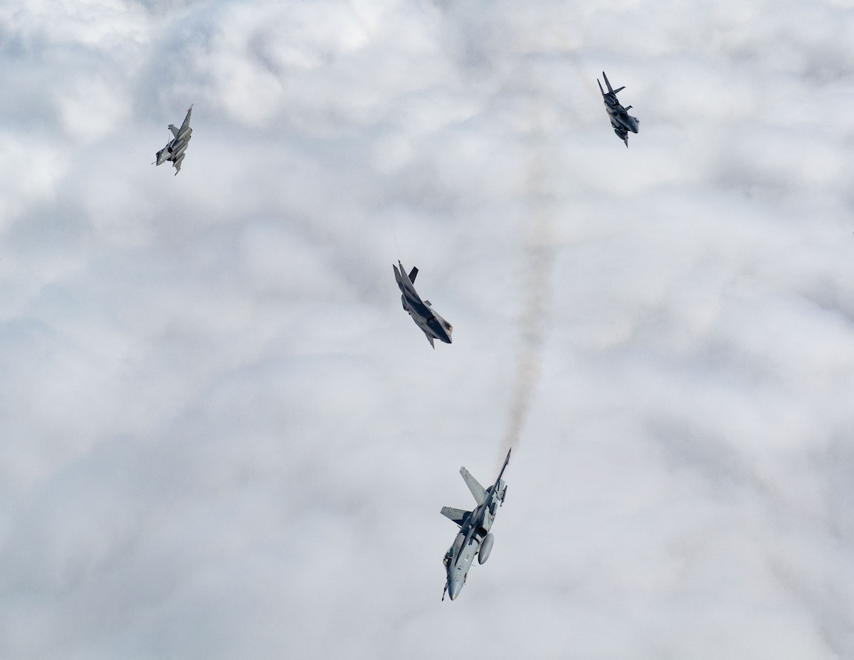A U.S. F-15E Strike Eagle, U.S. F-35A Lightning II, Finnish F/A-18 Hornet and French Rafale break away from a formation during exercise Atlantic Trident 25 over Finland, June 20, 2025. The exercise built military capability and warfighting capacity between the U.S., U.K., France and Finland to support deterrence and defense of the Euro-Atlantic region, ensuring continued readiness, adaptability and lethality. (U.S. Air National Guard photo by Airman 1st Class Bridget Rossignol)