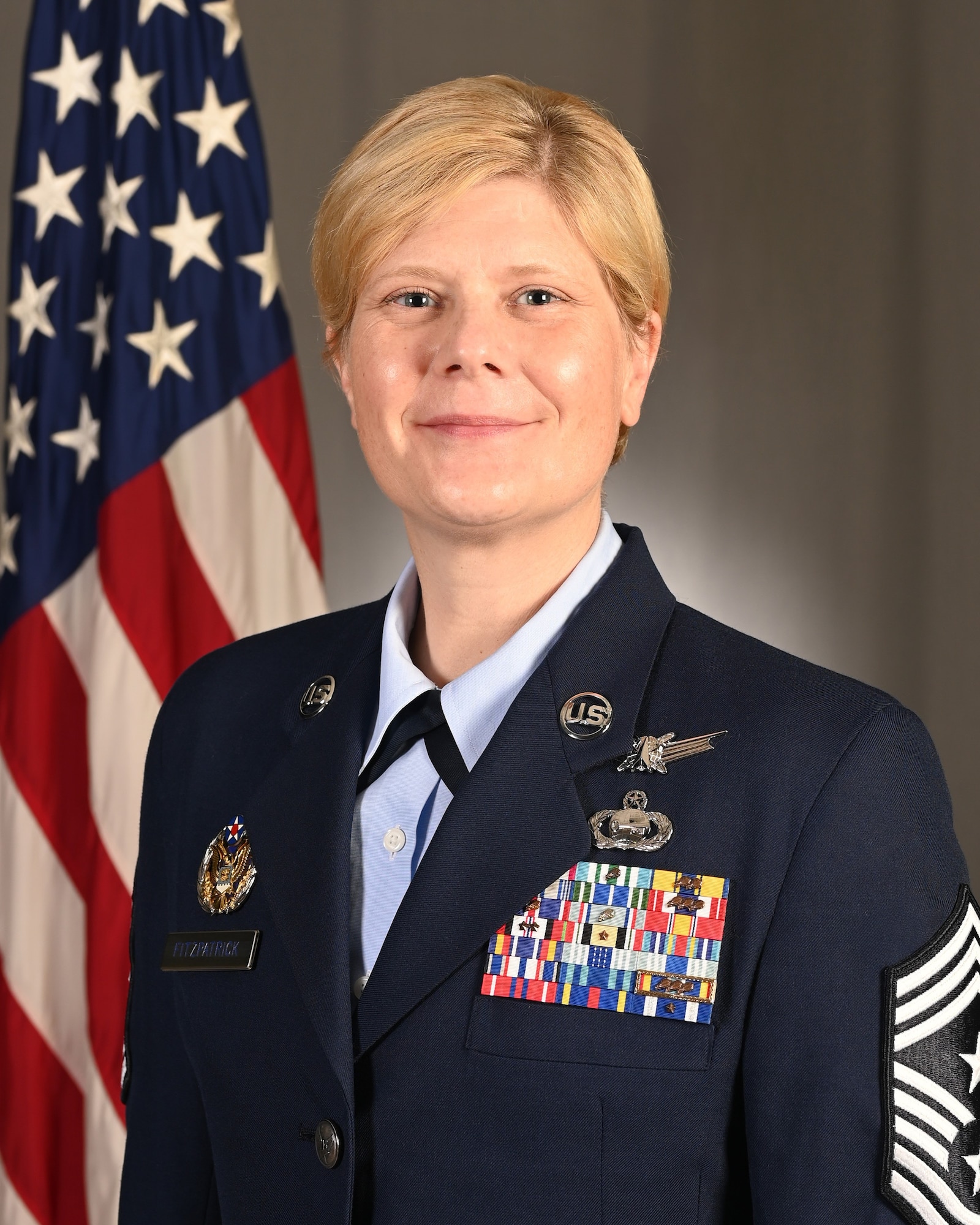 Official Air Force photo of Chief Master Sergeant Theresa Fitzpatrick, 363d ISR Wing command chief, in front of U.S. flag