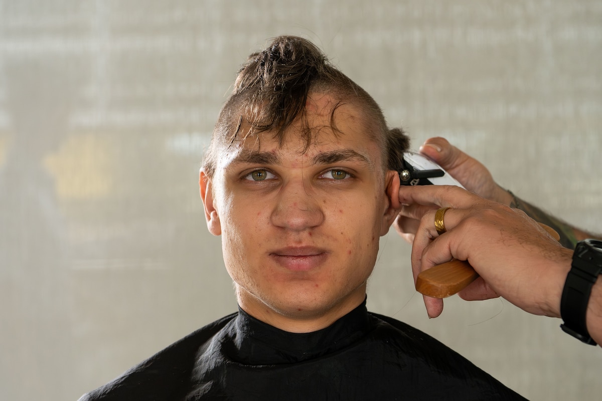 A basic cadet candidate from the class of 2029 receives a haircut at the U.S. Air Force Academy during in-processing, or I-Day, June 25, 2025, in Colorado Springs, Colo. I-Day marks the start of a cadet's journey to become a commissioned officer in the U.S. Air Force or U.S. Space Force. (U.S. Air Force photo by Dylan Smith)