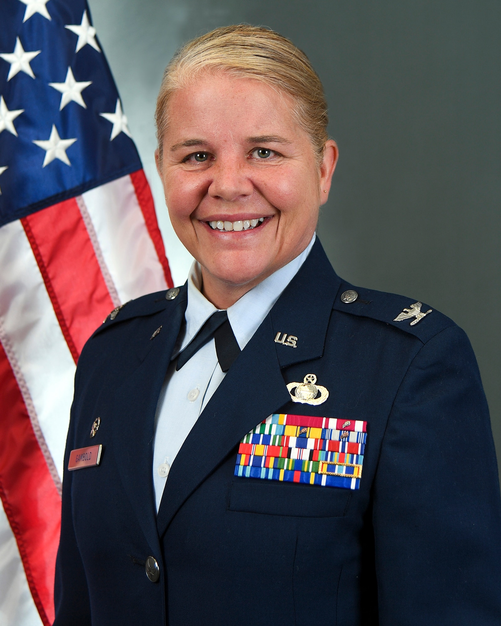 Official studio photo for Colonel Catherine Gambold. Individual standing in front of U.S. Flag in a studio.