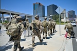 U.S. Army Soldiers with Alpha Company, 1st Battalion, 184th Infantry Regiment, California Army National Guard, arrive at the Wilshire Federal Building in Los Angeles, June 22, 2025. About 100 Soldiers deployed to the site to assist U.S. Marines in protecting federal property and manning security points. U.S. Northern Command is supporting federal agencies by providing military forces to protect federal functions, personnel, and property in the greater Los Angeles area. On June 7, the Secretary of Defense directed USNORTHCOM to establish Task Force 51 to oversee Title 10 forces supporting this mission.
