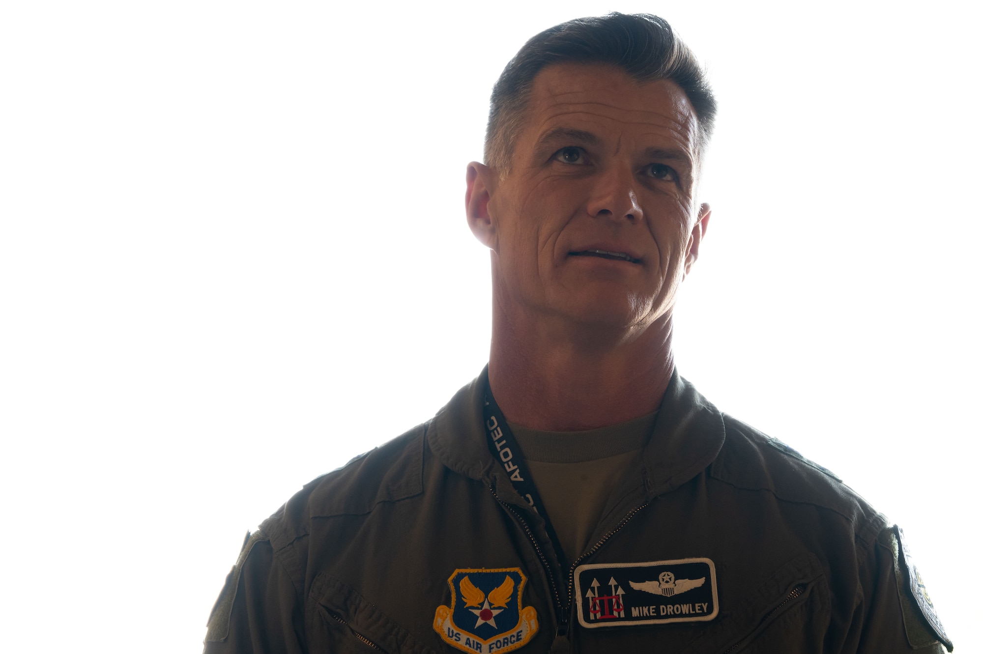 Maj. Gen. Michael Drowley looks up at an off-screen B-52H Stratofortress.