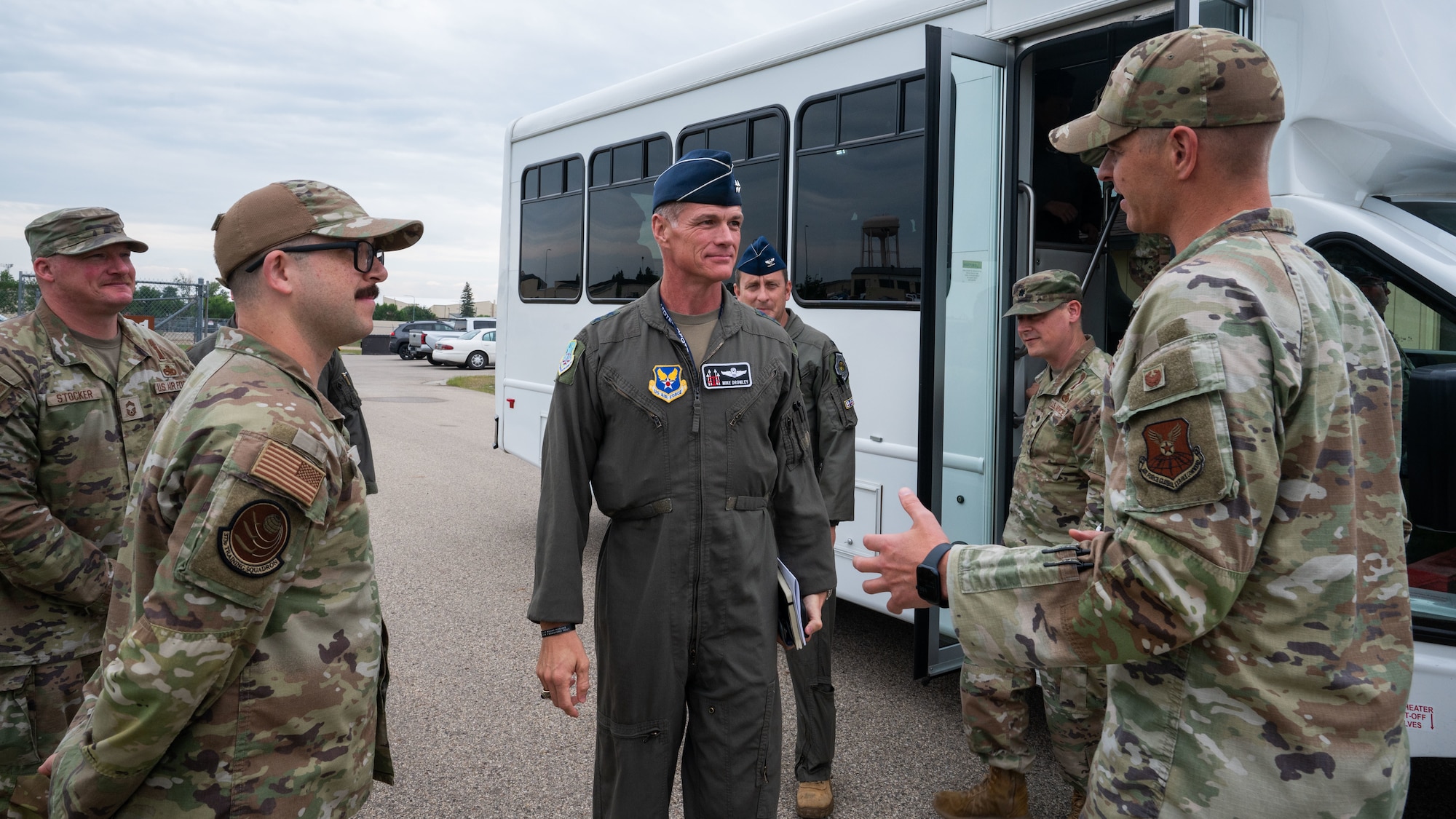 Airmen from the 373rd Training Squadron greet Maj. Gen. Michael Drowley shortly after he leaves a bus.