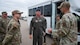 Airmen from the 373rd Training Squadron greet Maj. Gen. Michael Drowley shortly after he leaves a bus.
