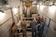 A group of Airmen look around the inside of Uniform-01's payload transporter.