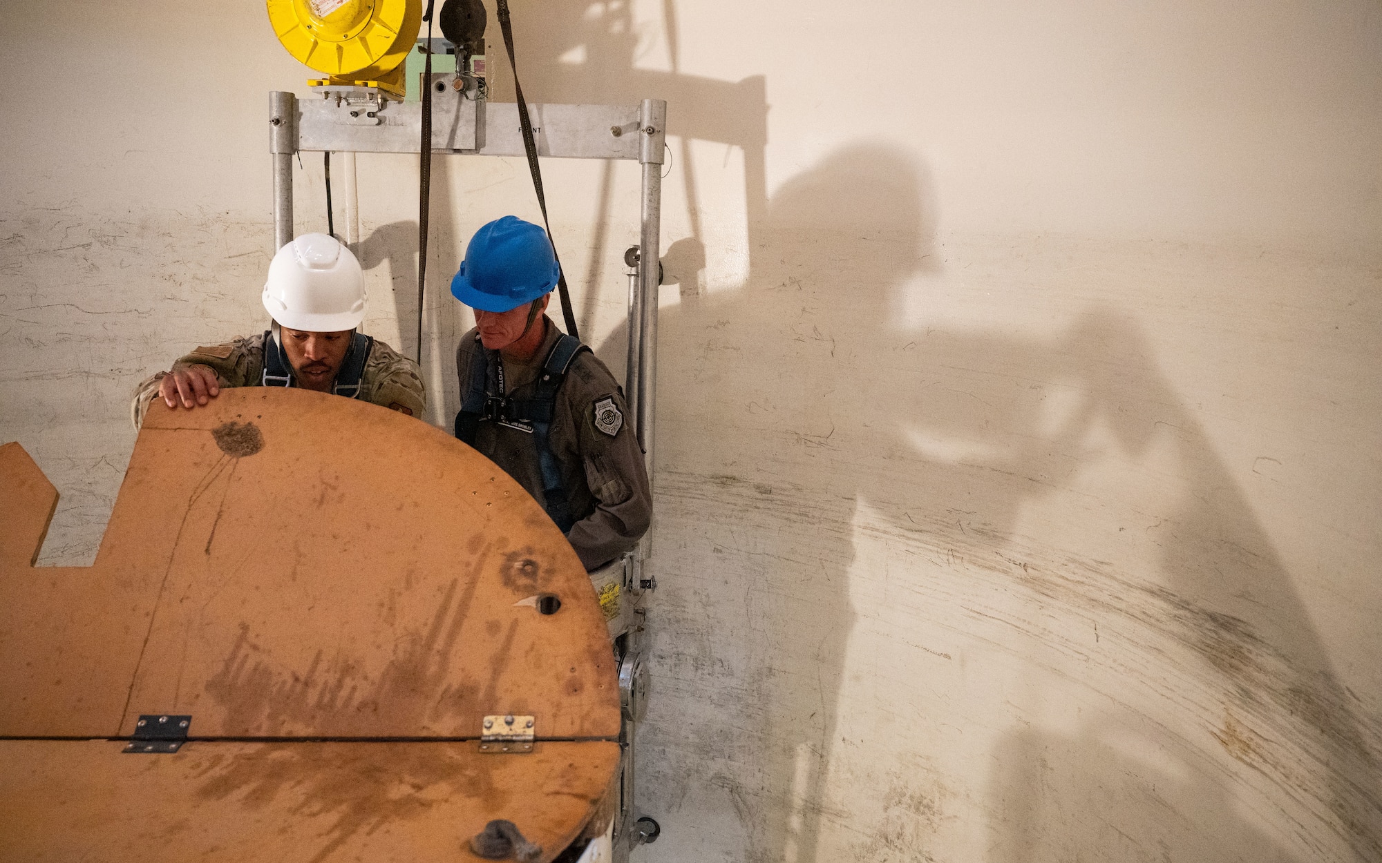 An Airman shows Maj. Gen. Michael Drowley the interior of a missile guidance set.
