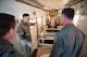 A missile maintenance team Airman shows around the interior of a payload transporter.