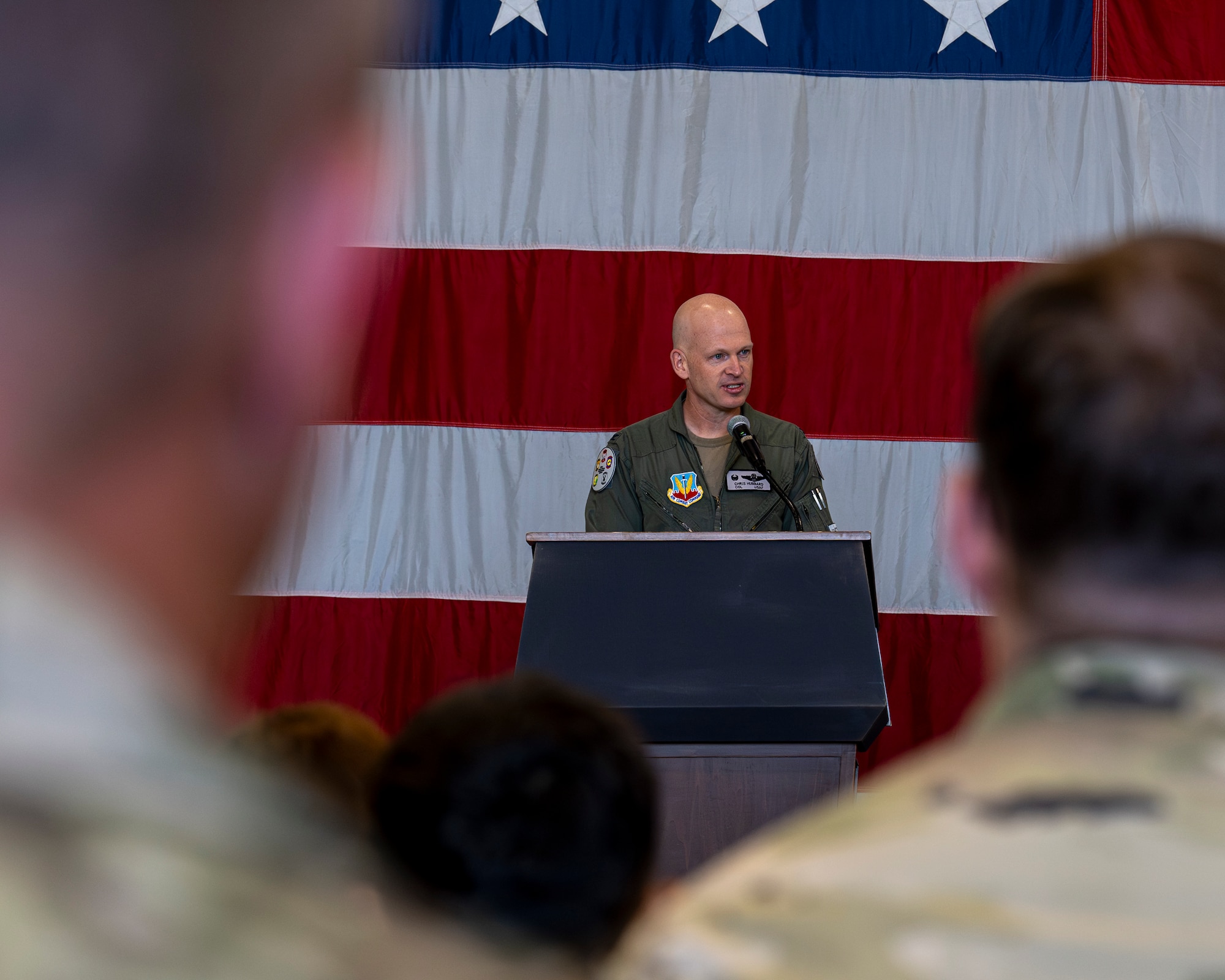A photo of an officer at a podium during a change of command ceremony