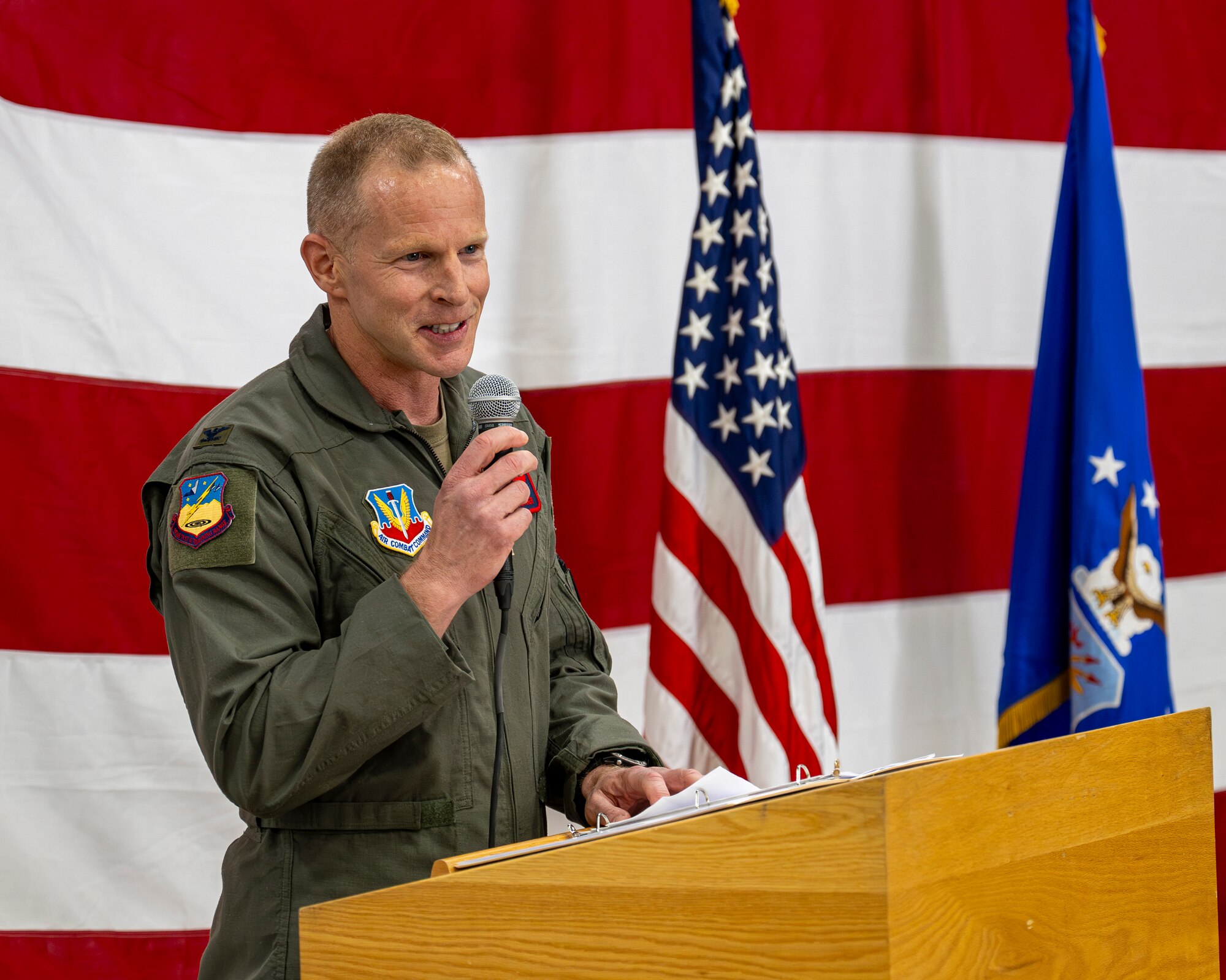 A photo of an officer at a podium during a change of command ceremony