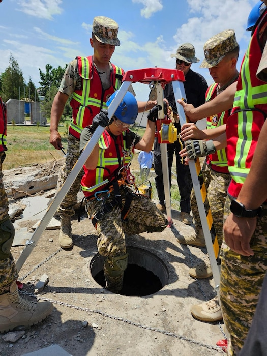Member from the Kyrgyz Republic repels down a manhole during exercise Ak Shumkar 2025.