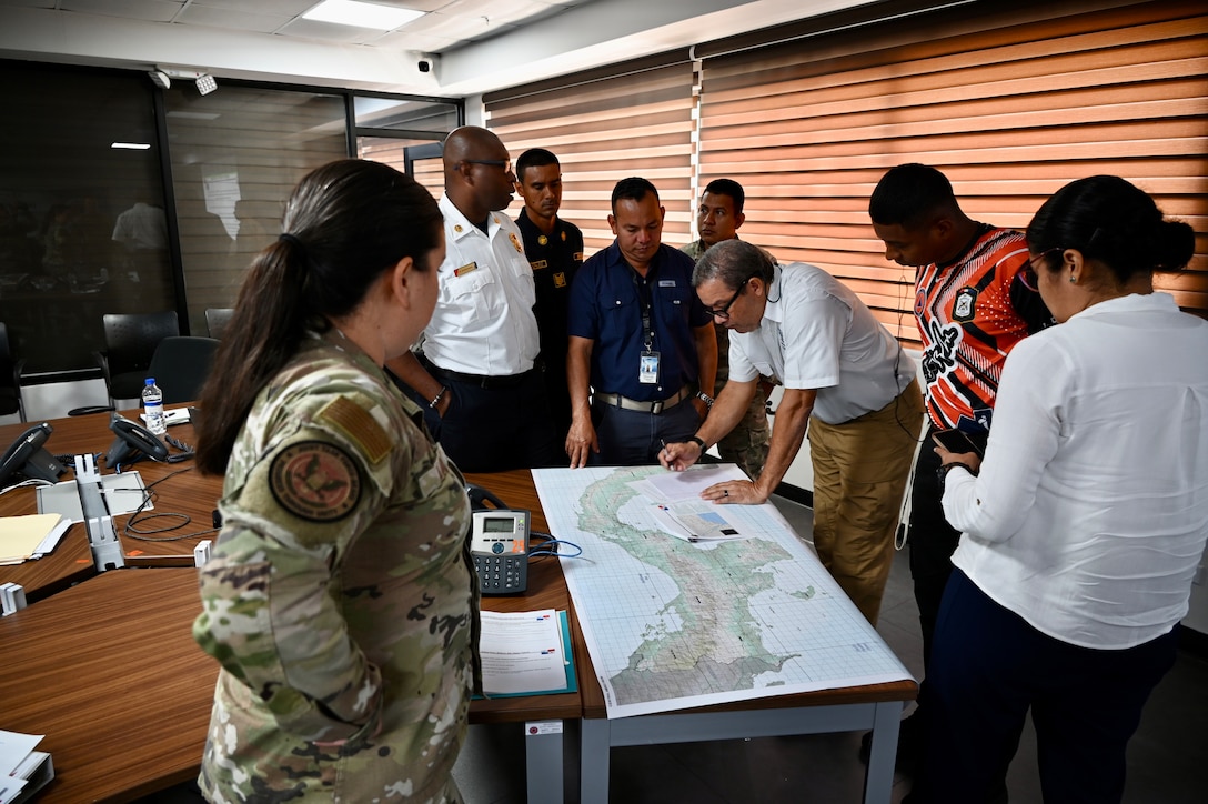 Exercise personnel view a map to determine areas affected during the exercise scenario.