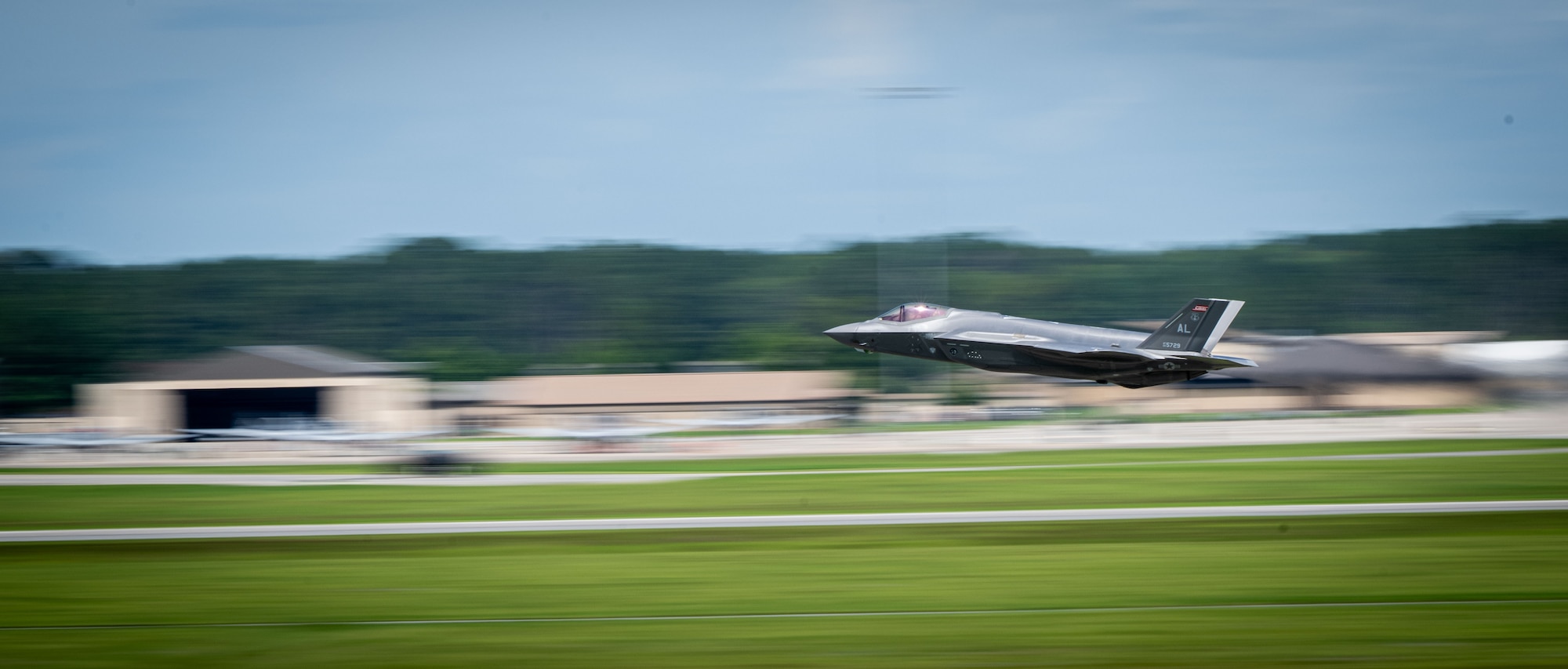 A U.S. Air Force F-35A Lightning II from the 187th Fighter Wing flies at low-level during a comprehensive noise exercise at Moody Air Force Base, Georgia, June 18, 2025. The exercise evaluated the perceived noise levels inside base housing units during peak F-35A flight operations. (U.S. Air Force photo by 1st Lt. Benjamin Williams)