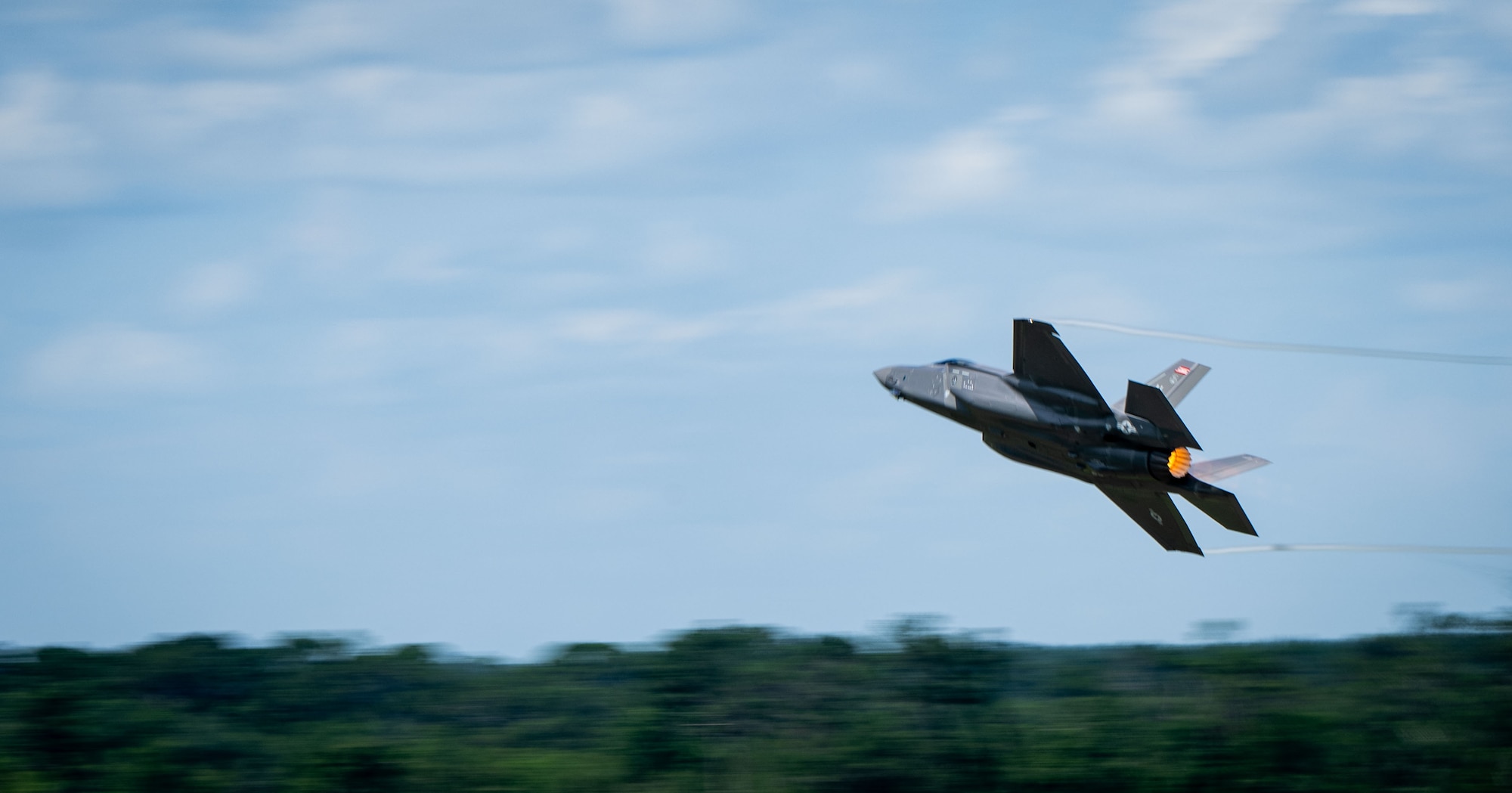 A U.S. Air Force F-35A Lightning II from the 187th Fighter Wing flies at low-level during a comprehensive noise exercise at Moody Air Force Base, Georgia, June 18, 2025. The exercise explored the combined effects of the F-35A noise profile with other existing environmental sounds in the area. (U.S. Air Force photo by 1st Lt. Benjamin Williams)