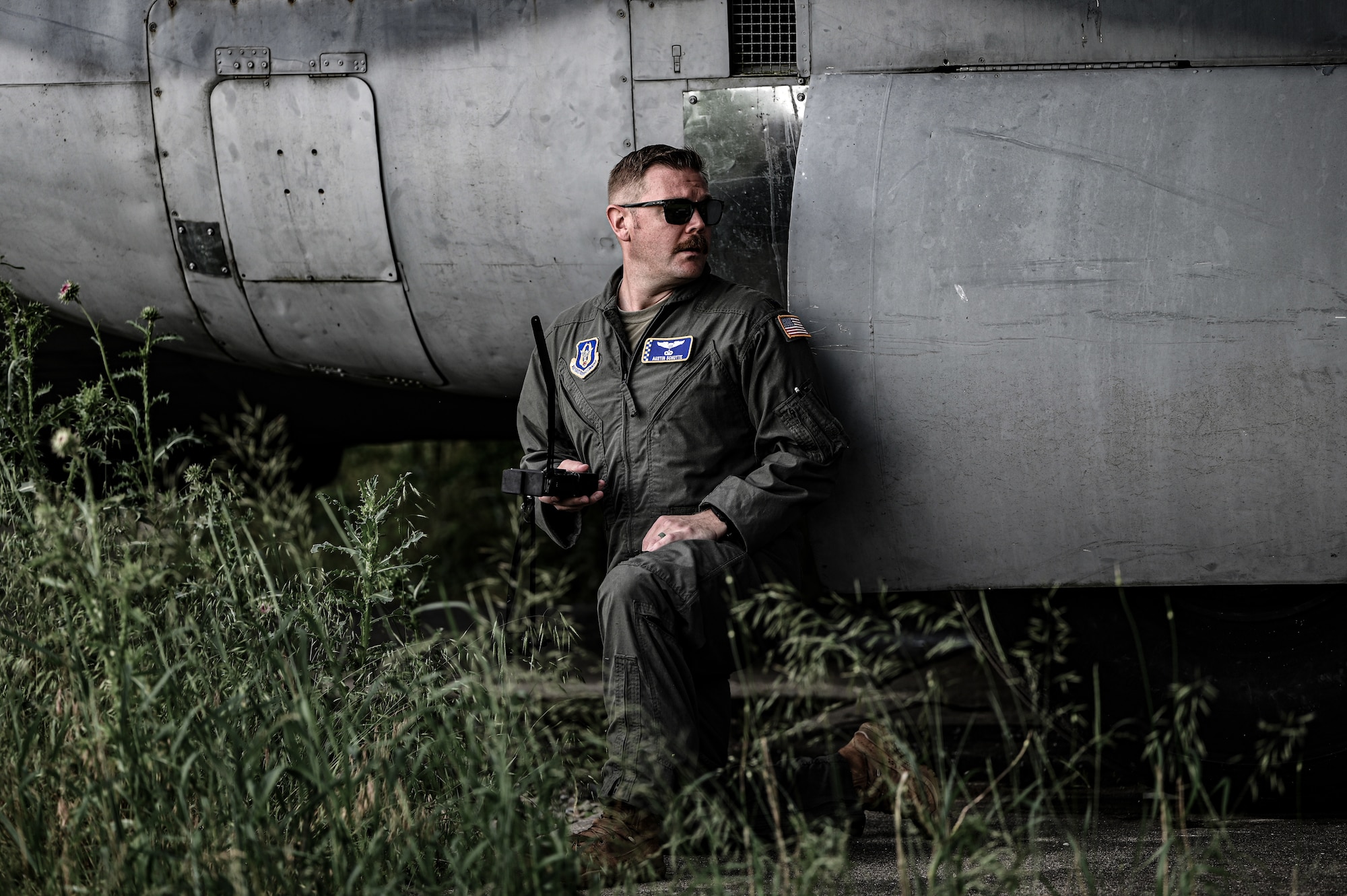 U.S. Air Force 1st Lt. Austin Schutte, 89th Airlift Squadron C-17 Globemaster III pilot, takes cover and utilizes a handheld radio during a Survival Evasion Resistance Escape (SERE) personnel recovery training at Wright-Patterson Air Force Base, Ohio, June 7, 2025. The training is used by pilots and crew members to maintain their knowledge should they become a downed pilot. (U.S. Air Force photo by Master Sgt. Patrick OReilly)