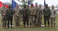 Michigan Army National Guard, stand for a photo in front of a white pine – Michigan’s state tree – dedicated near the Camp Grayling chapel to symbolize the strength of the Michigan-Liberia partnership