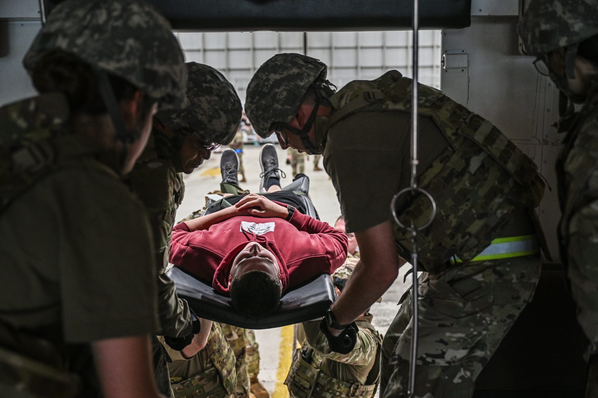 U.S. Airmen with the 445th Aeromedical Staging Squadron transport a simulated casualty onto a medical bus during Exercise Relentless Valor at Wright-Patterson Air Force Base, Ohio, June 7, 2025. The exercise which included U.S. Army, U.S. Air Force, U.S. Navy and U.S. Marine Corps members was designed to enhance the joint force’s ability to maneuver and conduct missions in contested, degraded and operationally limited environments. (U.S. Air Force photo by Master Sgt. Patrick OReilly)