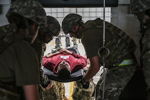 U.S. Airmen with the 445th Aeromedical Staging Squadron transport a simulated casualty onto a medical bus during Exercise Relentless Valor at Wright-Patterson Air Force Base, Ohio, June 7, 2025. The exercise which included U.S. Army, U.S. Air Force, U.S. Navy and U.S. Marine Corps members was designed to enhance the joint force’s ability to maneuver and conduct missions in contested, degraded and operationally limited environments. (U.S. Air Force photo by Master Sgt. Patrick OReilly)