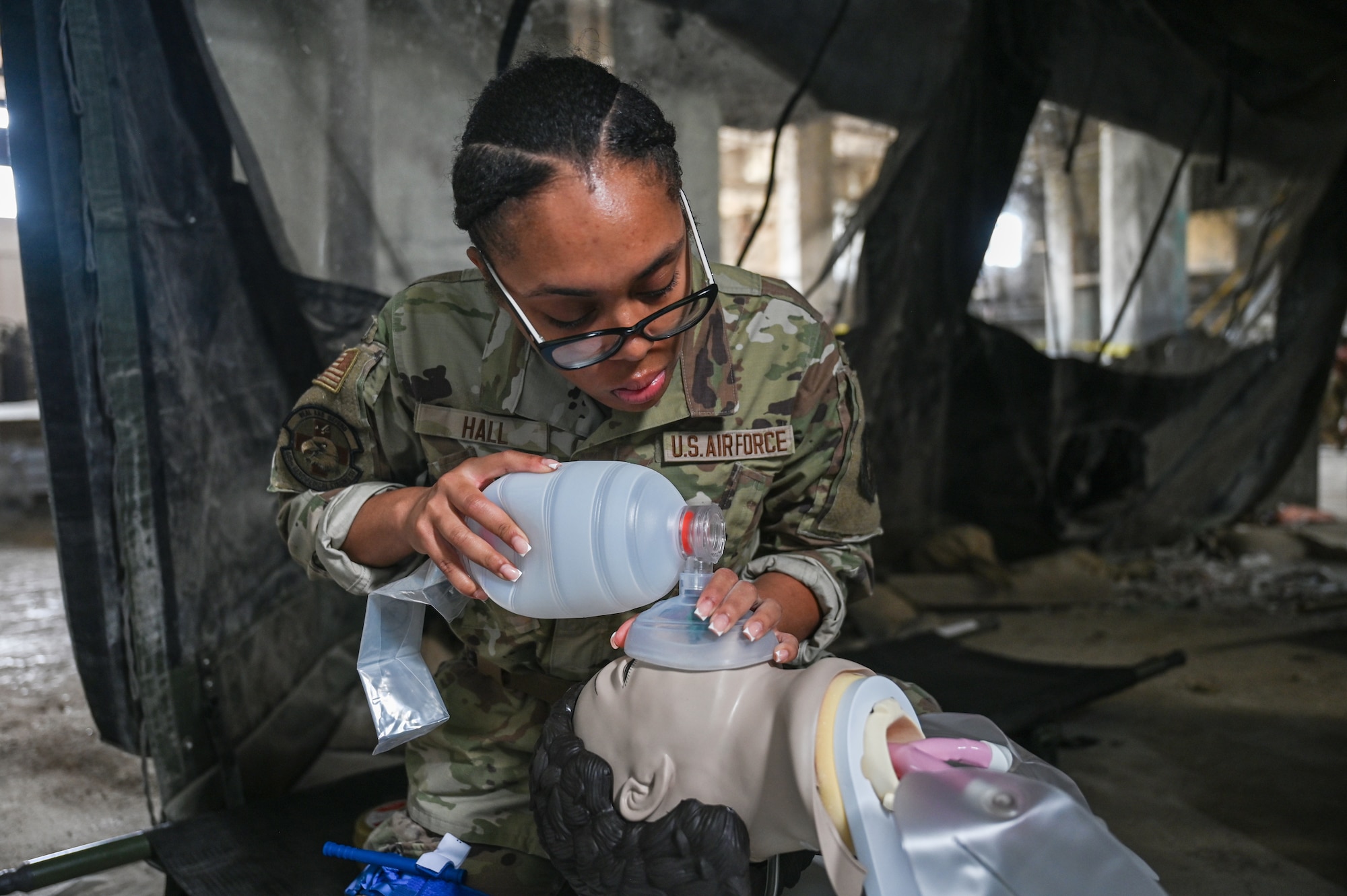 U.S. Air Force Airman 1st Class Ronnae Hall, 445th Aeromedical Staging Squadron medical technician administrator, provides medical care to a simulated casualty during Tactical Combat Casualty Care training for Exercise Relentless Valor at Wright State University's Calamityville, Fairborn, Ohio, June 6, 2025. Calamityville is a training, testing and research venue where military and civilian emergency first responders hone their skills while building relationships. The exercise was designed to enhance the joint force’s ability to maneuver and conduct missions in contested, degraded and operationally limited environments. (U.S. Air Force photo by Master Sgt. Patrick OReilly)