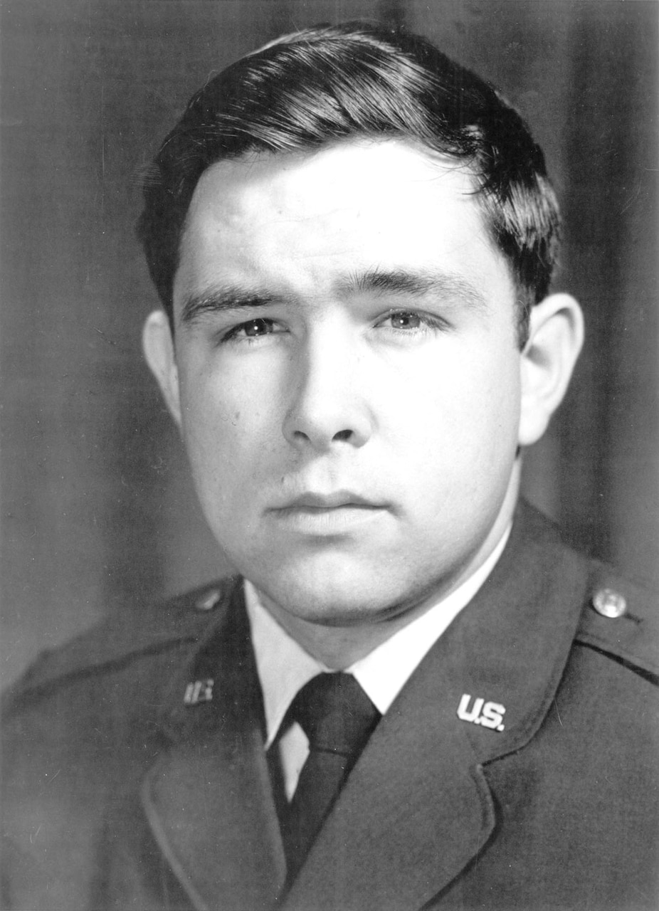 A man in a military dress uniform poses for a photo.