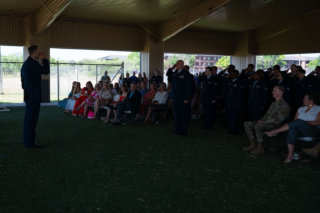 U.S. Air Force Airmen assigned to the 17th Mission Support Group present Col. Nathan Olsen, 17th Mission Support Group commander, with his first salute upon taking command at the 17th Security Forces Squadron kennels, Goodfellow Air Force Base, Texas, June 26, 2025. The 17th MSG is composed of six squadrons responsible for all aspects of logistical and personnel support on Goodfellow. (U.S. Air Force Photo by Airman 1st Class Brian Lummus)