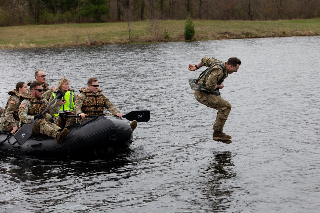 Iowa Army National Guard Sgt. Spencer C. Gull, a cavalry scout team leader with Alpha Troop, 1st Squadron, 113th Cavalry Regiment, 2nd Brigade Combat Team, 34th Infantry Division, jumps into the water and begins his water treading evaluation during the combat water survival test event of the National Guard Region IV Best Warrior Competition at Fort McCoy, Wis., May 2, 2025. Soldiers demonstrated their swimming and water-treading abilities during the combat water survival test event. The National Guard Region IV Best Warrior Competition is an annual event where the state best warriors from Illinois, Indiana, Iowa, Michigan, Minnesota, Ohio, and Wisconsin compete in various warrior skill challenges, with the selected winners advancing to the national competition. (U.S. Army National Guard photo by Sgt. Cesar Salazar Jr.)