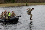Iowa Army National Guard Sgt. Spencer C. Gull, a cavalry scout team leader with Alpha Troop, 1st Squadron, 113th Cavalry Regiment, 2nd Brigade Combat Team, 34th Infantry Division, jumps into the water and begins his water treading evaluation during the combat water survival test event of the National Guard Region IV Best Warrior Competition at Fort McCoy, Wis., May 2, 2025. Soldiers demonstrated their swimming and water-treading abilities during the combat water survival test event. The National Guard Region IV Best Warrior Competition is an annual event where the state best warriors from Illinois, Indiana, Iowa, Michigan, Minnesota, Ohio, and Wisconsin compete in various warrior skill challenges, with the selected winners advancing to the national competition. (U.S. Army National Guard photo by Sgt. Cesar Salazar Jr.)