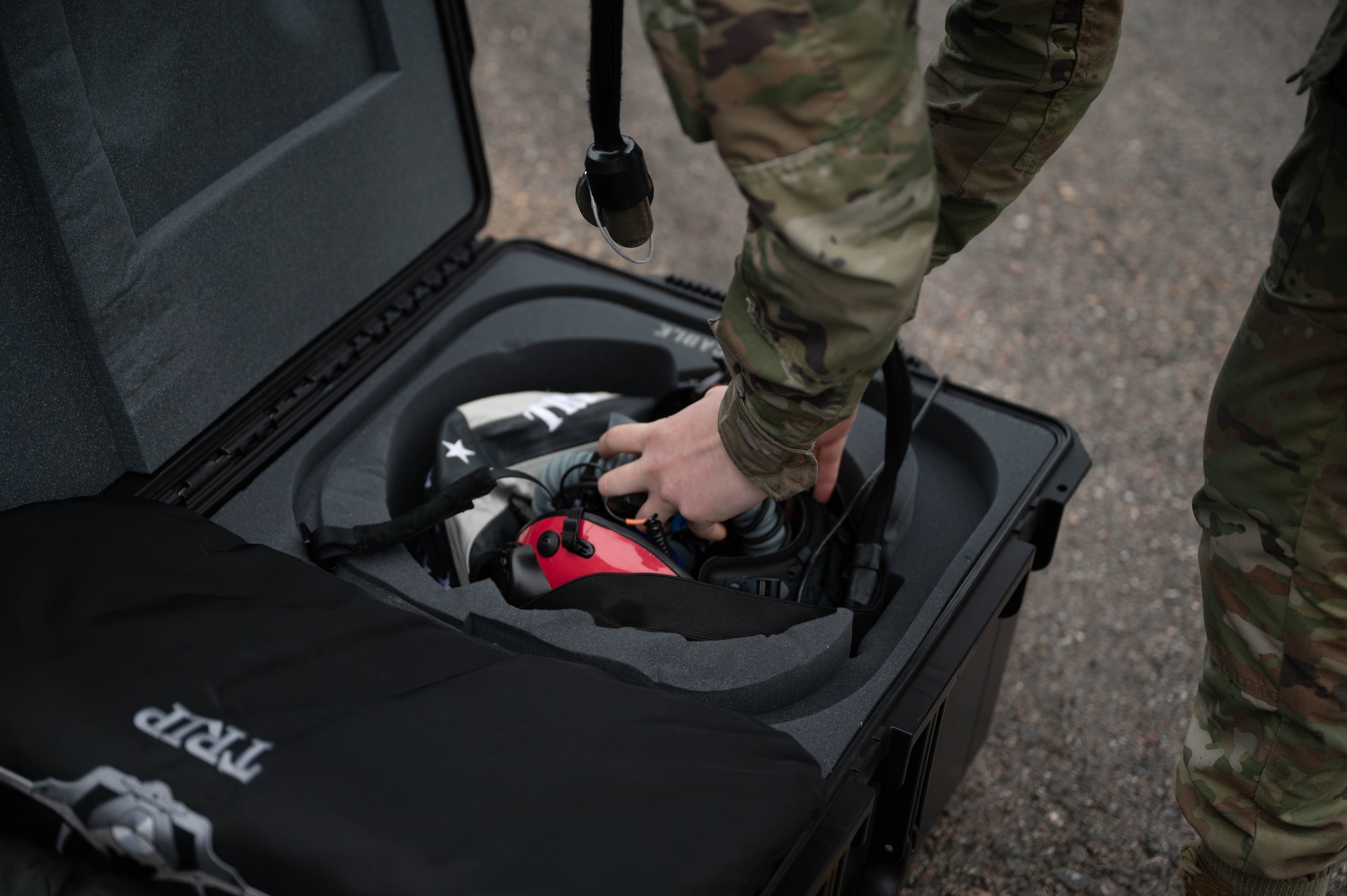 U.S. Air Force Senior Airman Lacy Toal, 495th Fighter Squadron lead aircrew flight equipment technician, packs a pilot helmet into its case during exercise Atlantic Trident 25 at Pirkkala Air Base, Finland, June 26, 2025. Toal was responsible for coordinating, packing and transporting each participating aircrew member’s gear during AT 25, ensuring each pilot’s readiness for daily training sorties. (U.S. Air Force photo by Airman 1st Class Sierra Casteel)