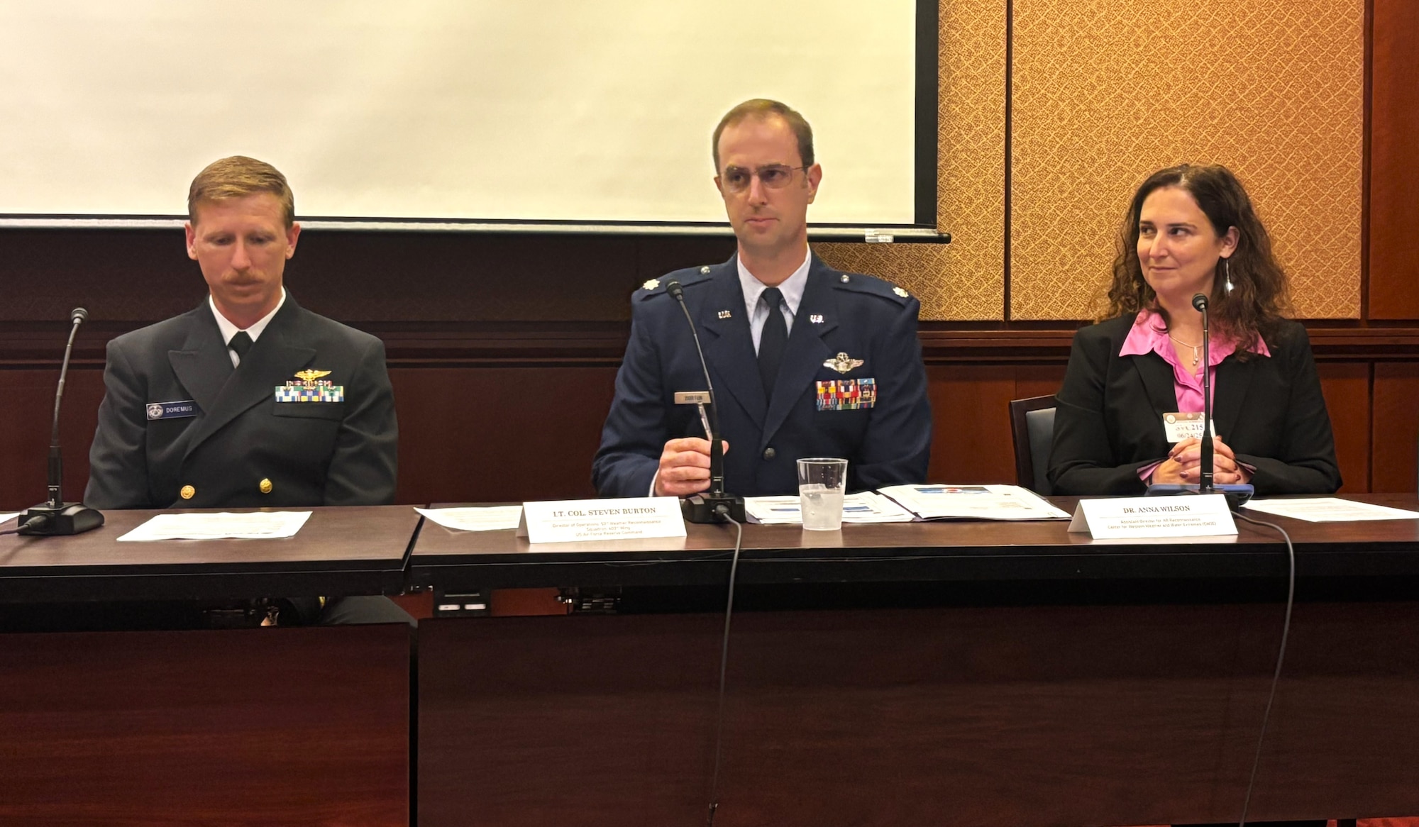 People sitting at a table briefing congressional staff members.