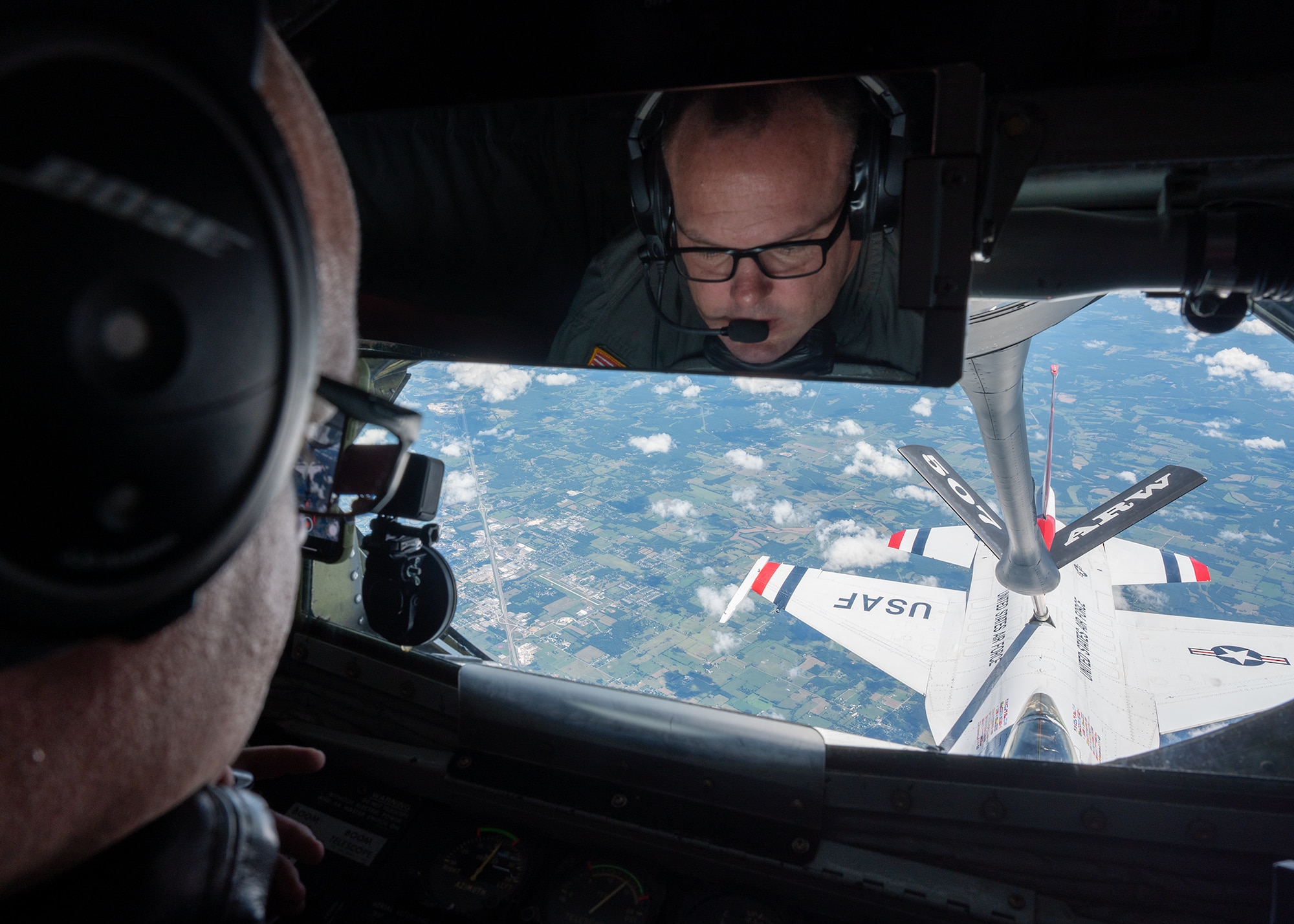 man looks at aircraft in flight from window of aircraft