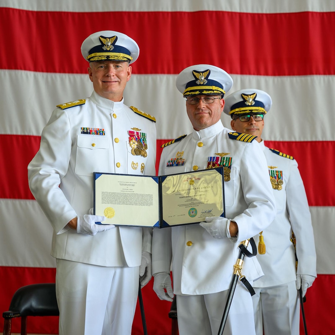Rear Adm. Douglas Schofield, commander of the Seventh Coast Guard District, awards Capt. Eric Smith with the Meritorious Service Medal award for his outstanding service and devotion to duty as commander of Air Station Miami, June 27, 2025. Capt. Smith was commander of Air Station Miami from June 2022 to June 2025. (U.S. Coast Guard photo by Auxiliarist Joey Feldman)