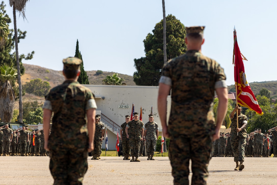 U.S. Marine Corps Sgt. Maj. Lawrence Hudson, command sergeant major, Combat Logistics Regiment 17, 1st Marine Logistics Group, retrieves the unit colors during a change of command ceremony on Marine Corps Base Camp Pendleton, California, June 26, 2025. The change of command ceremony symbolizes the passing of authority and responsibility from the outgoing to the incoming commanding officer. CLR-17 is prepared to serve as the Logistics Combat Element headquarters for 1st MLG forward, where its mission is to be capable of general distribution, maneuver support, maintenance, supply, health services, general engineering, and Explosive Ordnance Disposal support. (U.S. Marine Corps photo by Lance Cpl. Deja Rogers)