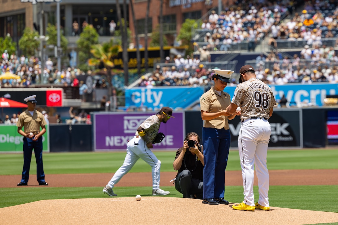 U.S. Marines with Marine Heavy Helicopter Squadron (HMH) 465, Marine Aircraft Group 16, 3rd Marine Aircraft Wing stand in line to get a baseball signed by Padres players at a San Diego Padres military appreciation pre-game ceremony at Petco Park in San Diego, June 22, 2025. The Padres host Military Salutes throughout the season to honor the service of military personnel, recognize their accomplishments, and celebrate key moments in military history. (U.S. Marine Corps photo by Lance Cpl. Jeslianne A. Torres)